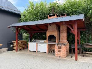a brick oven with a roof on a patio at La Luna Imobiliare in Ocna-Mureşului