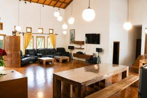 a living room with a couch and a table at Villa New IMS in Bandung