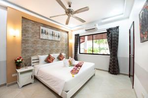 a bedroom with a white bed and a brick wall at MM Pool Villa in Pattaya South +60 photos