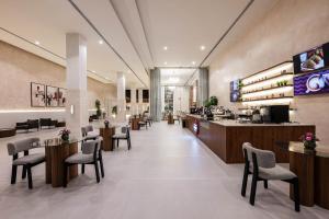 a lobby of a restaurant with tables and chairs at Sama Inn Hotel in Riyadh