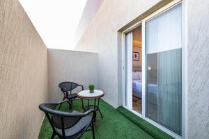 a small balcony with two chairs and a table at Sama Inn Hotel in Riyadh