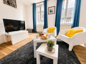 a living room with white furniture and a flat screen tv at Centre-Ville Appartement 90m2 Le Normand in Elbeuf