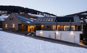 a house in the snow with lights on at Appartement Chalet Saalbach - incl Joker Card in Saalbach-Hinterglemm