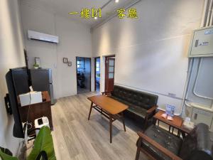 a living room with a couch and a table at 未半文旅 in Yilan City