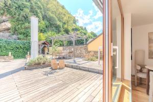 an open door to a deck with a view of a house at Hakuna Rooftop Penthouse Wachau in Spitz +6 photos