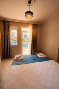 a bedroom with a large bed with a window at Konyaalti Suite Hotel in Antalya