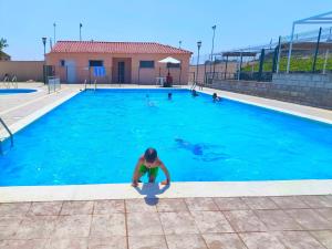 a man is standing in a swimming pool at El Clos 1 in Conesa