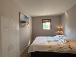 a small bedroom with a bed and a window at Sea Cottage in Westerland