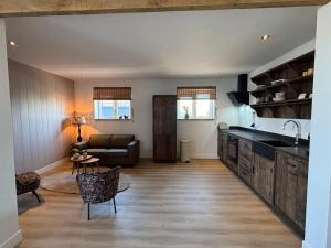 a kitchen and living room with a couch and a table at Sea Cottage in Westerland