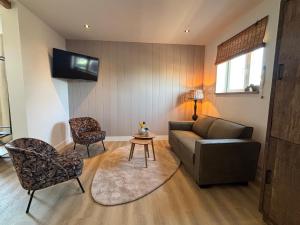 a living room with a couch and a chair at Sea Cottage in Westerland