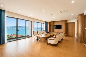 a conference room with a table and chairs and a large window at The Golden Crest Hotel Quy Nhon in Quy Nhon