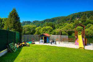 a backyard with a playground with a play structure at Chata u pltníka Paľka in Podbiel