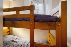 a couple of bunk beds in a room at Studio cabine - Les ecrins 2 in Valloire