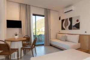 a living room with a couch and a table at Elpis Studio Apartments in Bali