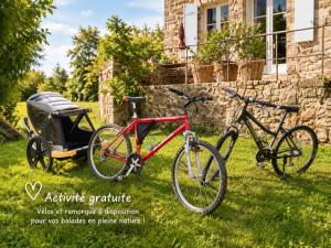 two bikes parked in the grass next to a carriage at "La Voûte de Pierre" Gîte indépendant in Saint-Cyr