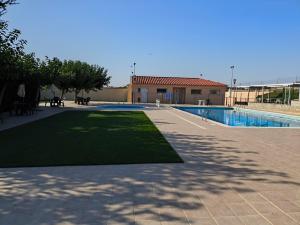 a courtyard with a swimming pool and a building at El Clos 3 in Conesa