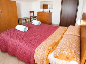 a bedroom with a bed with two pillows on it at MANSARDA COSTA BIANCA - Free Parking in Realmonte