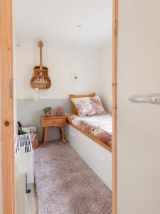 a small bedroom with a bed and a table at The Red Shutter Cottage in Hattemerbroek