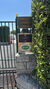 a sign in front of a fence at BluePrivateSpa in Latte