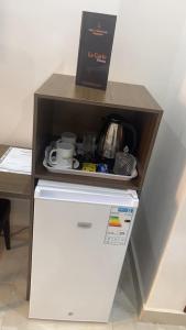 a box sitting on top of a refrigerator at Hôtel La Miséricorde in Douala
