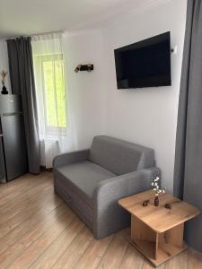 a living room with a couch and a coffee table at Pine Forest Apartments in Pamporovo