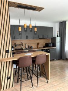 a kitchen with a wooden table and some chairs at Pine Forest Apartments in Pamporovo