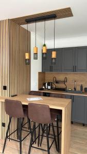 a kitchen with a wooden table and chairs at Pine Forest Apartments in Pamporovo +69 photos