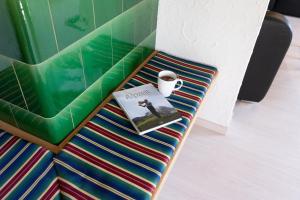 a book and a cup of coffee sitting on a bench at Central in Wildhaus +19 photos