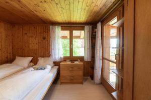a small bedroom with a bed and a window at Central in Wildhaus