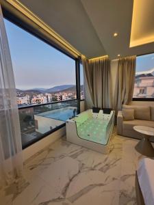 a hotel room with a view of a pool at Rooftop panoramic jacuzzi room in Ksamil