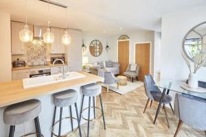 a kitchen and living room with a table and chairs at The Hampton Garden in Whitby