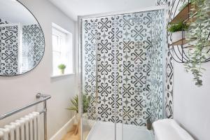a shower with a glass door in a bathroom at The Hampton Garden in Whitby +8 photos