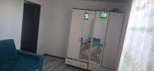 a white cabinet with a glass door in a room at Amir in Chon-Dzhargylchak
