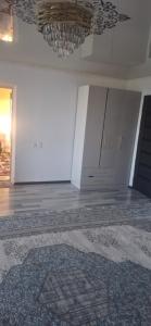 an empty room with white cabinets and a rug at Amir in Chon-Dzhargylchak