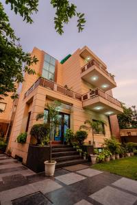 a building with a staircase in front of it at Royal Residence 90 in Gumgaon