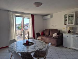 a living room with a table and a couch at Boutique Apartments Julija in Vodice