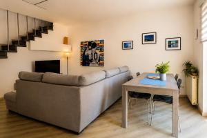 a living room with a couch and a table at Rocca Lake House in Angera