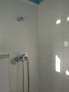 a shower with a shower head in a bathroom at Casinhas do Ribeiro in Póvoa de Lanhoso