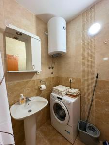 a bathroom with a washing machine and a sink at UnaMar 2 in Prčanj