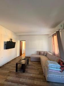 a living room with a couch and a flat screen tv at UnaMar 2 in Prčanj