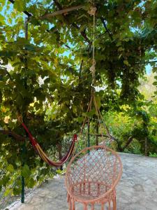 a wooden swing hanging from a tree at UnaMar 2 in Prčanj +1 photo