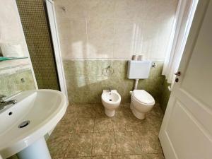 a bathroom with a toilet and a sink at Hotel Costa Doro - Salve in Salve