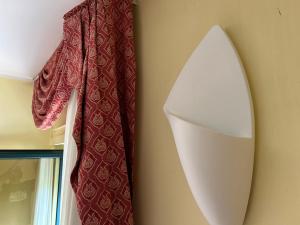 a towel hanging on a wall next to a surfboard at Hotel Costa Doro - Salve in Salve +12 photos