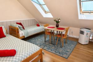 a small room with a table and chairs and a bed at Agroturystyka Staroscin in Rzepin