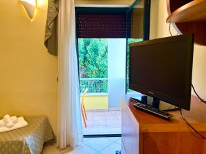 a computer monitor sitting on a desk in front of a window at Hotel Costa Doro - Salve in Salve