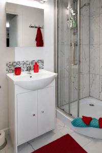 a white bathroom with a sink and a shower at Agroturystyka Staroscin in Rzepin +40 photos