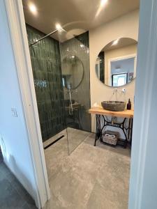 a bathroom with a sink and a shower with a mirror at EtnaDetox Vineyard Open Space in Castiglione di Sicilia