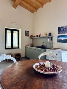 a kitchen with a table with a plate of food on it at EtnaDetox Vineyard Open Space in Castiglione di Sicilia