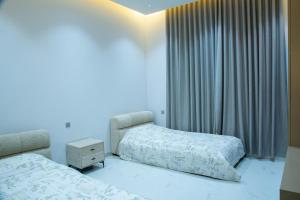 a hotel room with two beds and a window at Ubar-Salalah in Salalah +45 photos
