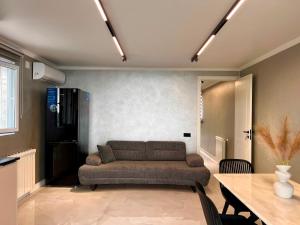 a living room with a couch and a table at Botanic sea view in Batumi